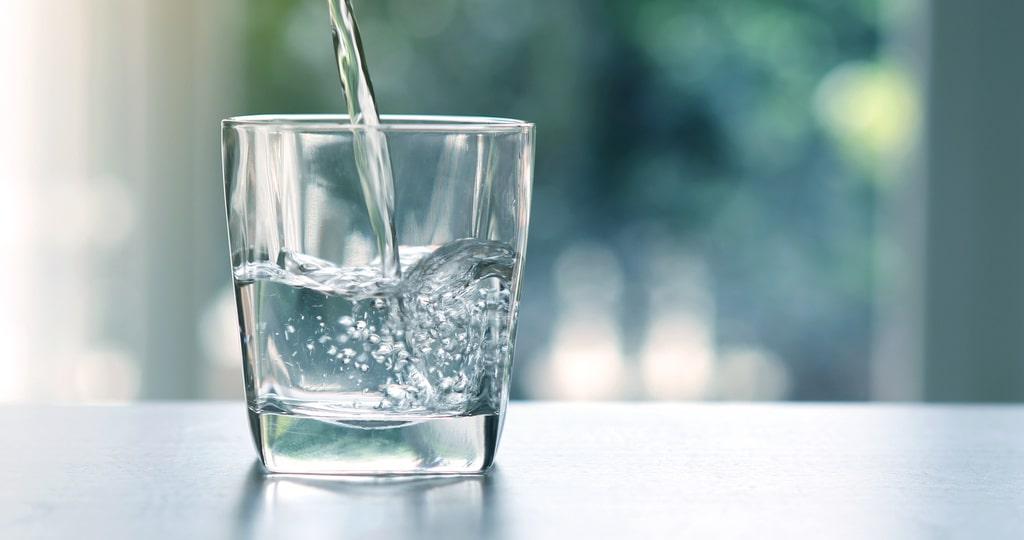 pouring purified fresh drink water from the bottle